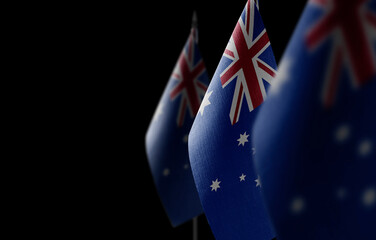 Small national flags of the Australia on a black background