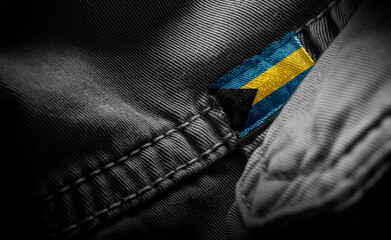 Tag on dark clothing in the form of the flag of the Bahamas