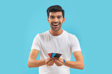 A young man showing his credit cards.	