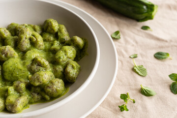 Homemade gnocchi with zucchini cream, typical Italian food