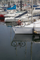 Detail image of bicycle in a boat and its reflection in the water with other boats in the foreground