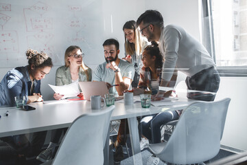 Group of programmers an designers in conference room.They discussing about development of new...