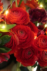 Red ranunculus with light garland