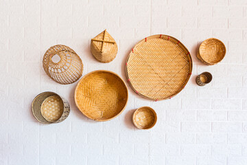 Fototapeta na wymiar Group of bamboo wicker model (fishing traps) on wall.