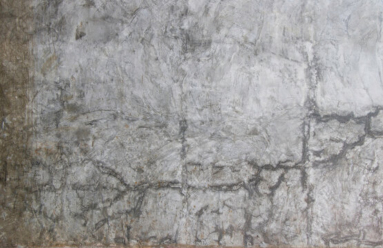 Concrete wall texture with cracks, dirt and paint splash.