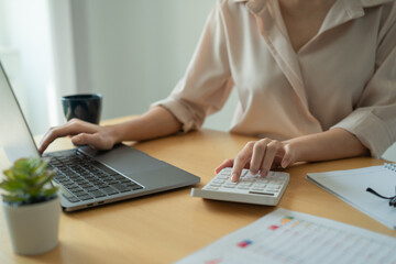 Fototapeta premium Businesswoman calculating budget numbers, Invoices, and financial adviser working.