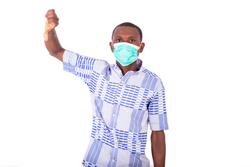 portrait of a young man wearing a medical mask making okay