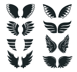 Set of hand drawn bird or angel wings of different shape in open position. Contoured vector doodle wings set