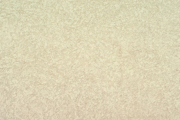 Plaster on a yellow wall. Concrete wall texture close up.