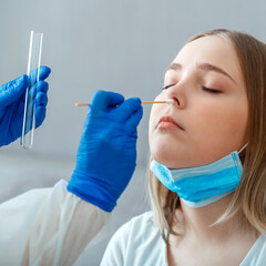 Diagnostics testing patients coronavirus covid. Doctor taking PCR test nasopharyngeal culture to woman patient. Nurse take saliva sample through nose with cotton swab check coronavirus covid 19 test