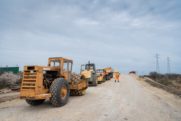 large machines, excavators and rollers for leveling the ground, road construction