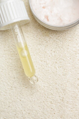Nourishing and hydrating facial serum, antirid cream and facial sponge, close up image. 
