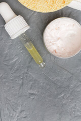 Nourishing and hydrating facial serum, antirid cream and facial sponge, close up image. 