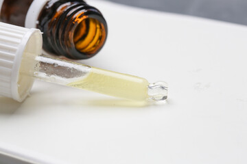 Nourishing and hydrating facial serum in glass dropper, close up image