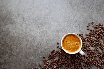 hot espresso and coffee beans on old cement floor background. top view. flat lay. space for text