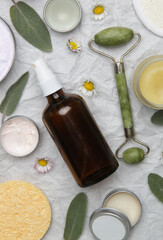 Natural organic skin care products. Home spa and self care product top view. Facial serums, essentials oils, creams, jade roller and soap bars 