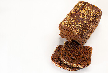 Homebaked bread. Gluten-free cereal with seeds and sesame seeds. Dark background.