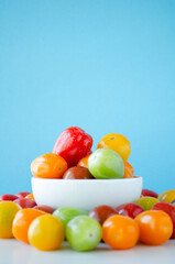 Cherry tomato in white bowl with background color 