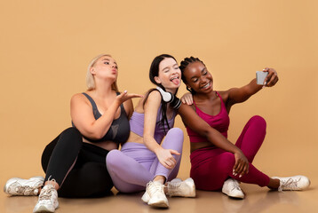 Cheerful Diverse Multiethnic Females In Sportswear Taking Selfie On Smartphone After Training