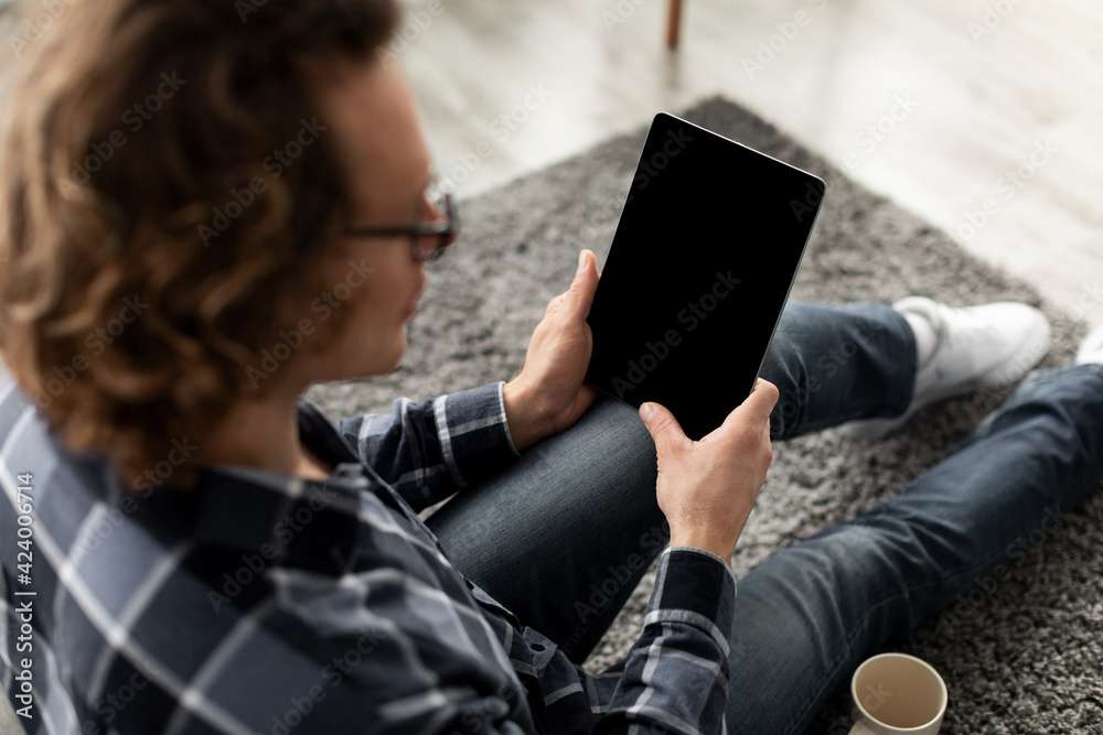 Poster Guy Using Digital Tablet Computer With Empty Screen At Home