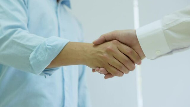 slow motion scene of investor businessman handshake with partner vendor to agreement or deal financial project concept