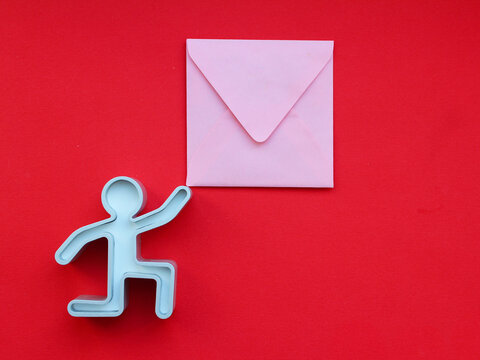 The human figure is holding an envelope, letter. Metal figure, delivery of mail, letters. place for your text. blank for design, layout.