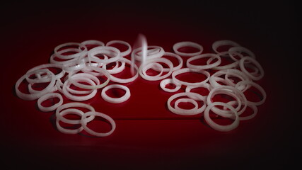 Onion rings falling on table. Close up view of falling white sliced ring onion.