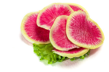 Radish cut into thin slices for salad on a white plate. Isolates.