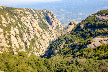 Fototapeta na wymiar View of the valley where the Montserrat Monastery tourist-religious complex is located from the Saint Joan funicular. Montserrat massif natural park, Catalonia, Spain