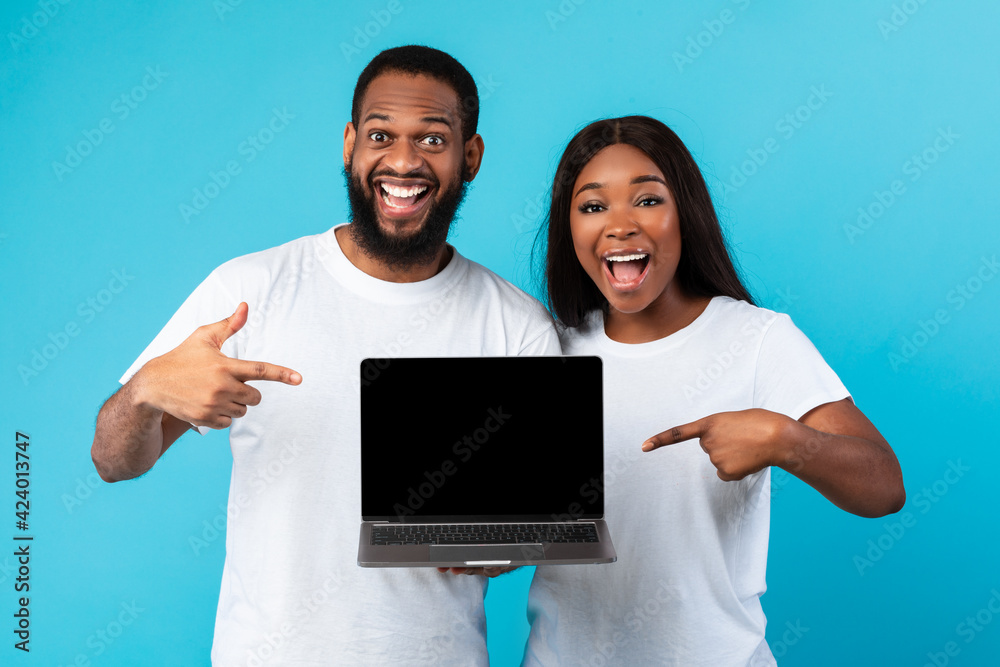 Wall mural black couple showing blank empty laptop screen for mockup