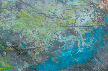 colorful creative motley background: smudged residues of oil paints on a wooden palette, short focus, selective blur