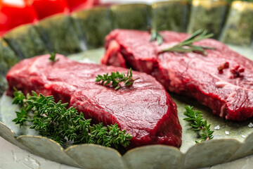 Pieces of cooked rump steak with spices served on old meat tray. Steak of marbled beef black Angus. Raw beef ramp steak, top view