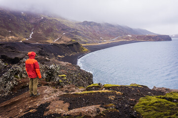 Fototapeta na wymiar Tourist looking at black beach of Lake Kleifarvatn near Krysuvik in Iceland, top view
