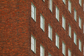 Red brick wall of Oslo City Hall with windows in Oslo, Norway