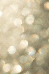 bright glitter background: bokeh effect from many colored lights on frozen glass, toning