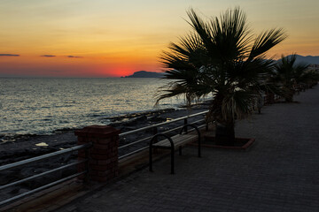 Bright red sunset on the background of the sea and the promenade in Alanya, Turkey