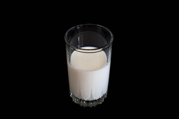 a glass of milk on a black background