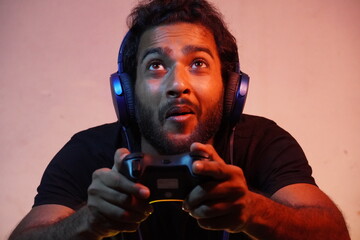 young man playing video game at home