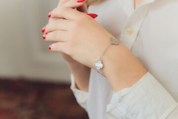 Woman's hands with perfect manicure with silver bracelet.