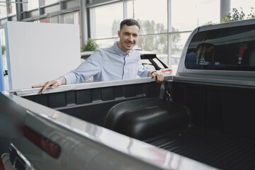 Handsome and elegant man in a car salon