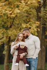 Family with little daughter in a autumn park