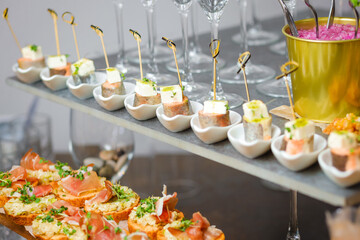 Catering service. Table with snacks food at event.