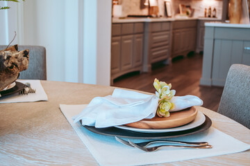 Kitchen interior design photos, place setting on the table. Light, bright modern homes living in luxury and style. Colors of white, blue, neutral - clean lines. Real estate photos.