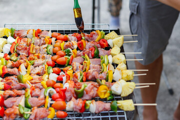 Blurred image,Barbecue (BBQ) skewered on a charcoal grill is a street food that is convenient for a party or picnic and barbecue (BBQ) is also increasing its popularity in many countries.