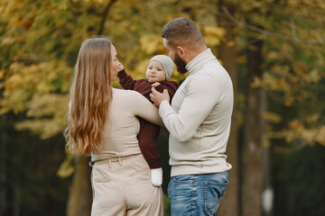 Family with little daughter in a autumn park