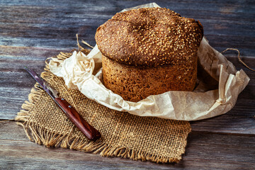 Traditional bread with a crust on a wooden board