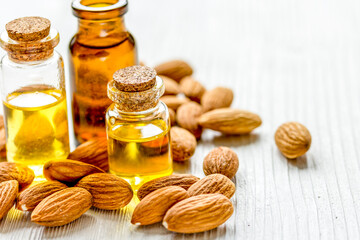natural oil and almond in cosmetic set on table background