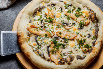 Pizza with bacon, tomatoes, cheese and olives. Italian Cuisine.