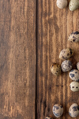 Easter picture with quail eggs on a wooden background. The minimal concept of Easter.  An Easter card with a place for the text. Blurred background.