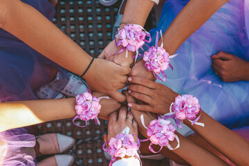 Girls holding hands, decorated with flowers